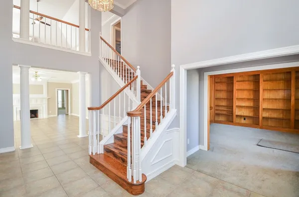 a view of entryway and hall with wooden floor