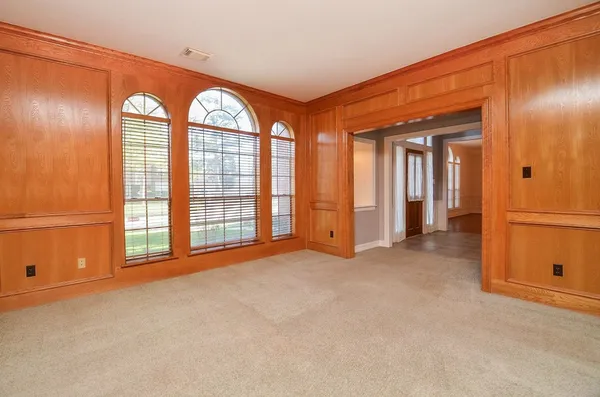 an empty room with windows and closet
