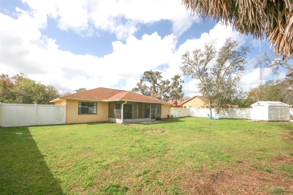 9297 Pickens Street Spring Hill, FL 34608 - Photo 13 of 40 a view of a house with a yard