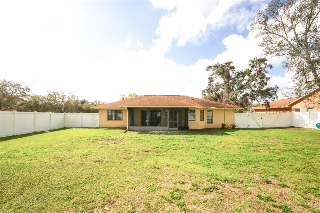 9297 Pickens Street Spring Hill, FL 34608 - Photo 14 of 40 a house with yard in front of it