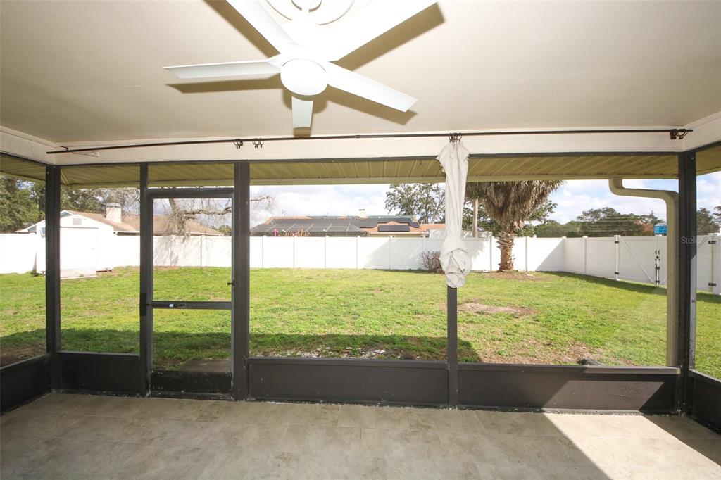 9297 Pickens Street Spring Hill, FL 34608 - Photo 17 of 40 a view of a glass door with a yard