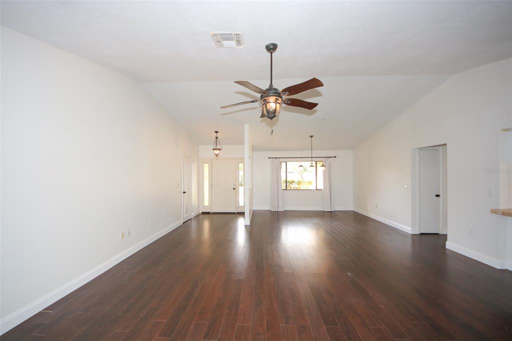 9297 Pickens Street Spring Hill, FL 34608 - Photo 19 of 40 an empty room with wooden floor fan and windows