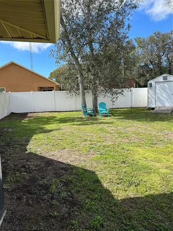 a view of a pool with a backyard of house