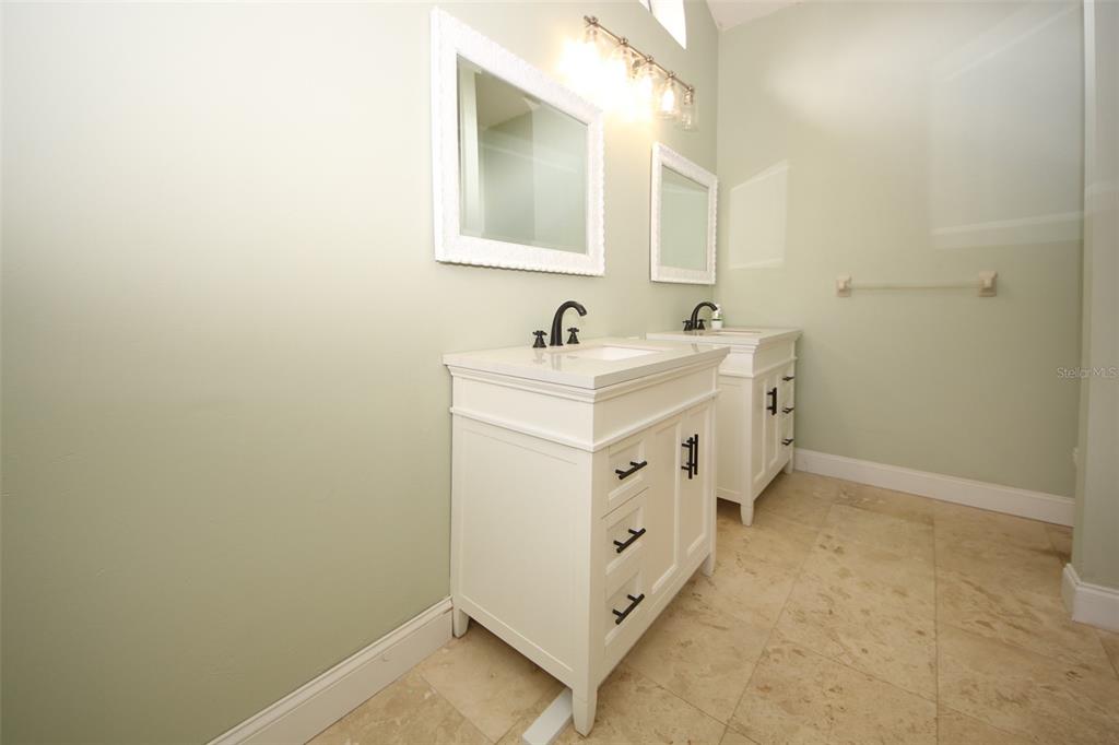 9297 Pickens Street Spring Hill, FL 34608 - Photo 22 of 40 a bathroom with a sink and a mirror