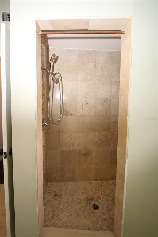 9297 Pickens Street Spring Hill, FL 34608 - Photo 23 of 40 a bathroom with a glass shower door