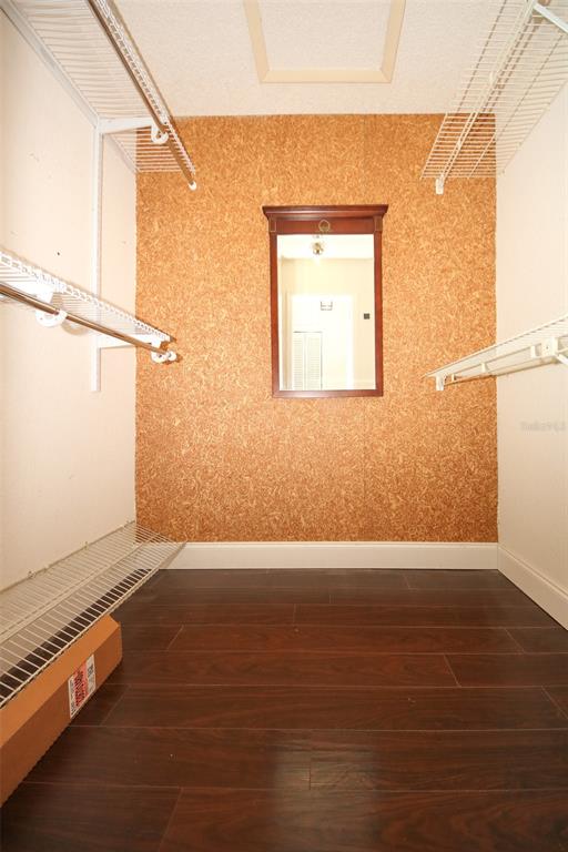 9297 Pickens Street Spring Hill, FL 34608 - Photo 25 of 40 an empty room with wooden floor and windows