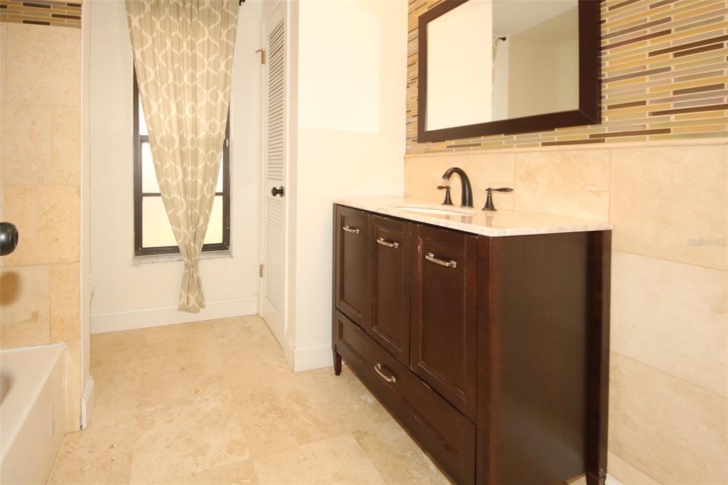9297 Pickens Street Spring Hill, FL 34608 - Photo 28 of 40 a bathroom with a sink and a mirror