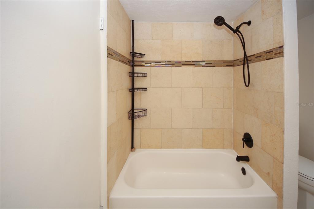 9297 Pickens Street Spring Hill, FL 34608 - Photo 30 of 40 a bathroom with a bathtub