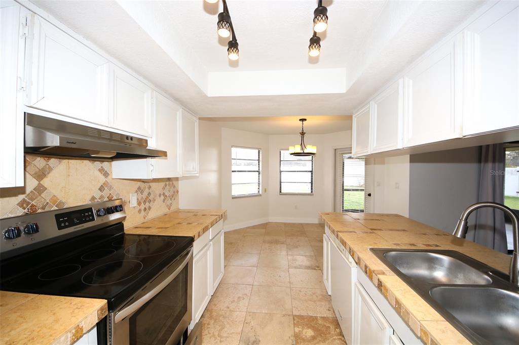 9297 Pickens Street Spring Hill, FL 34608 - Photo 35 of 40 a kitchen with a stove and a sink