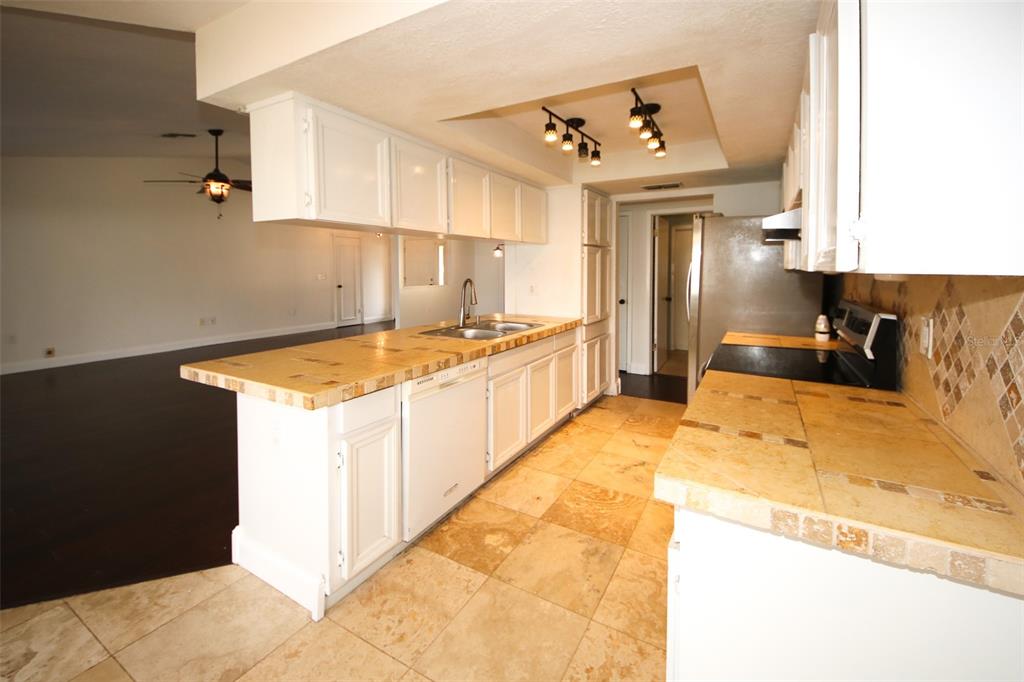 9297 Pickens Street Spring Hill, FL 34608 - Photo 36 of 40 a kitchen with a sink stove and refrigerator
