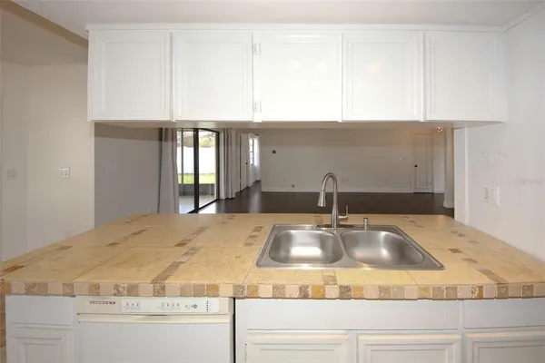 a stove top oven sitting inside of a kitchen