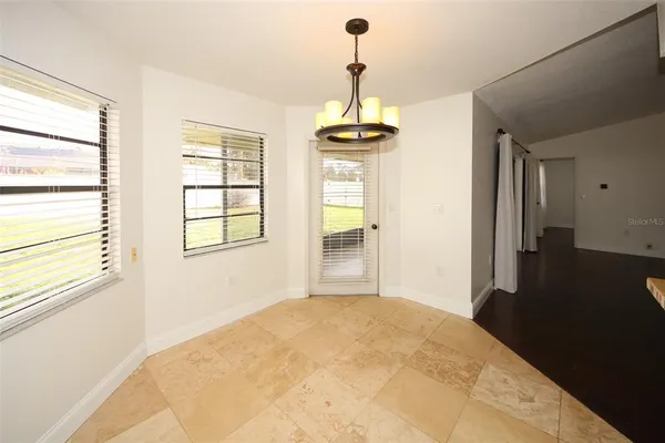 a kitchen with granite countertop a sink a stove and cabinets