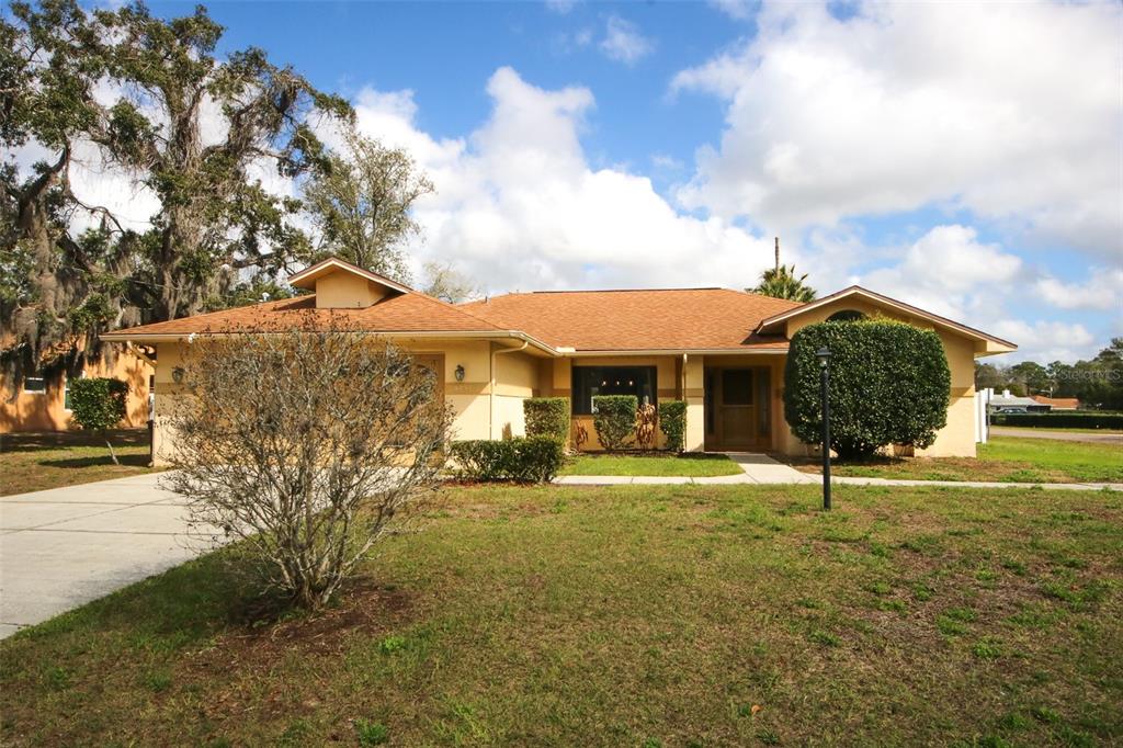 9297 Pickens Street Spring Hill, FL 34608 - Photo 6 of 40 a front view of a house with garden