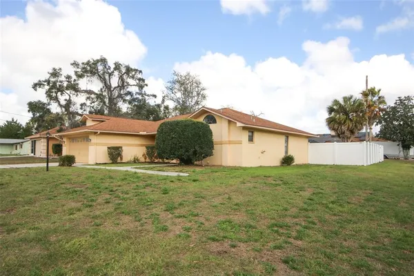 a house with green field in front of it