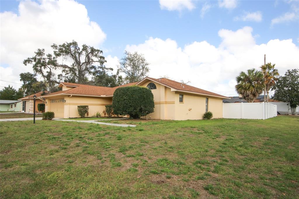 9297 Pickens Street Spring Hill, FL 34608 - Photo 8 of 40 a house with green field in front of it