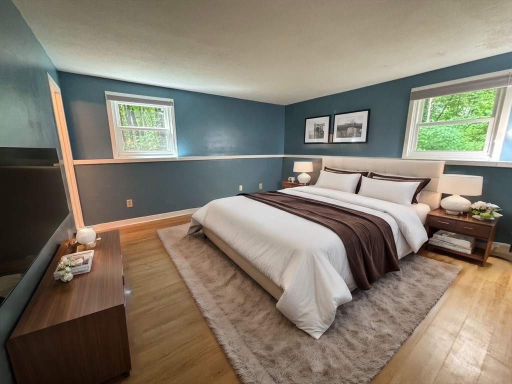 44 Evergreen Road, Unit 102 Leeds, MA 01053 - Photo 6 of 15 a bedroom with a bed and a night stand