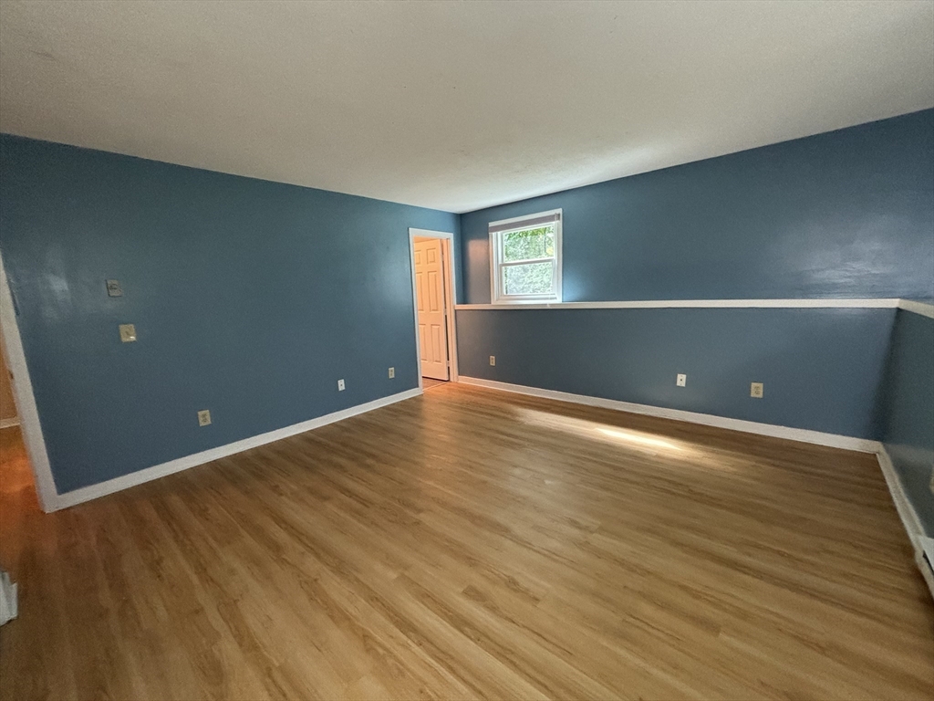 44 Evergreen Road, Unit 102 Leeds, MA 01053 - Photo 8 of 15 a view of empty room with wooden floor