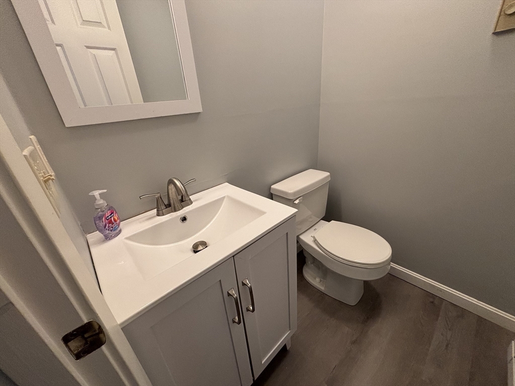 44 Evergreen Road, Unit 102 Leeds, MA 01053 - Photo 9 of 15 a bathroom with a sink mirror and toilet
