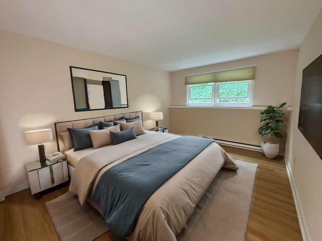 44 Evergreen Road, Unit 102 Leeds, MA 01053 - Photo 10 of 15 a bedroom with bed and a potted plant