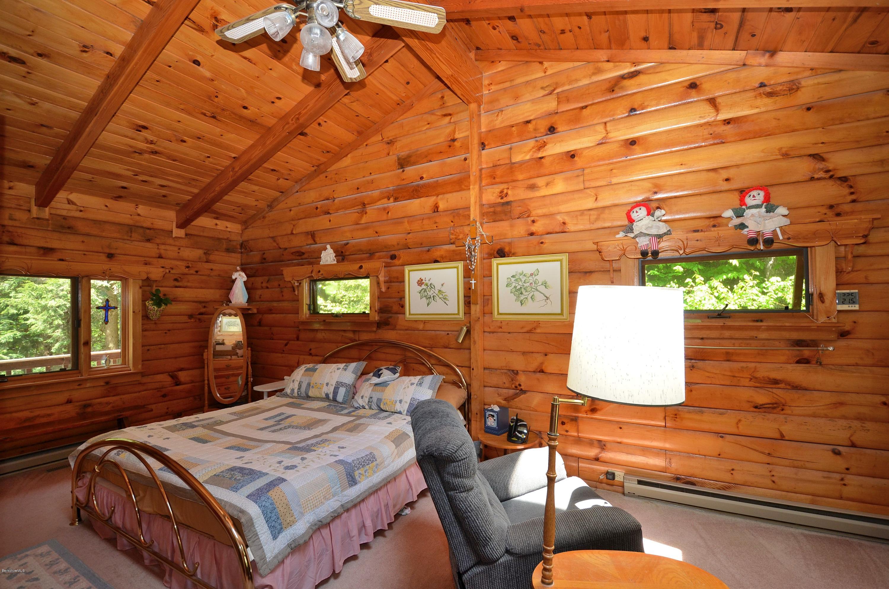 2379 West Center Road Otis, MA 01253 - Photo 8 of 17 a bedroom with a bed and wooden floor
