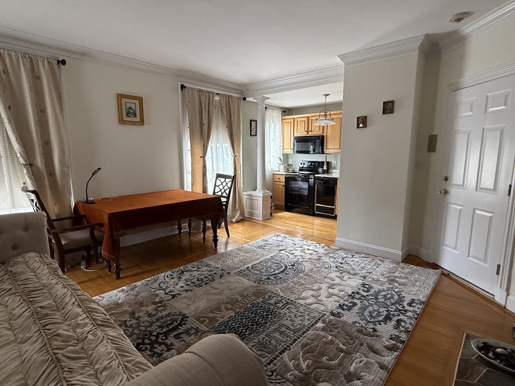 5 Porter Road, Unit 202 Andover, MA 01810 - Photo 5 of 17 a living room with a couch and a stove top oven