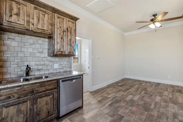 a kitchen with stainless steel appliances granite countertop a sink stove and cabinets
