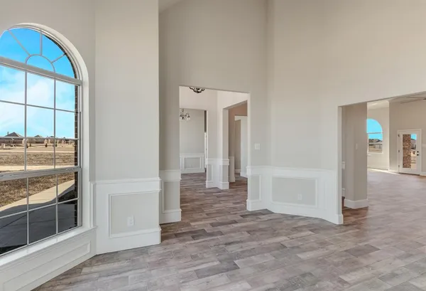 an empty room with wooden floor windows and a wooden floor