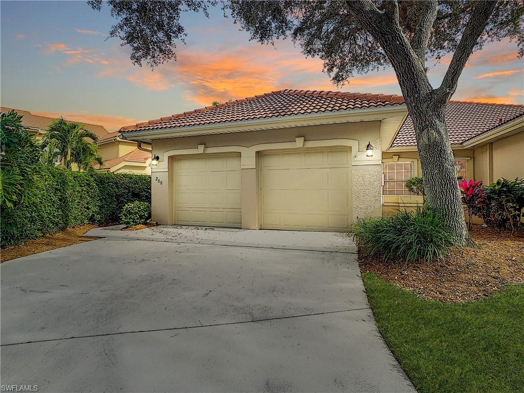 200 Napa Ridge Road East, Unit 6 Naples, FL 34119 - Photo 1 of 28 a front view of a house with a garden