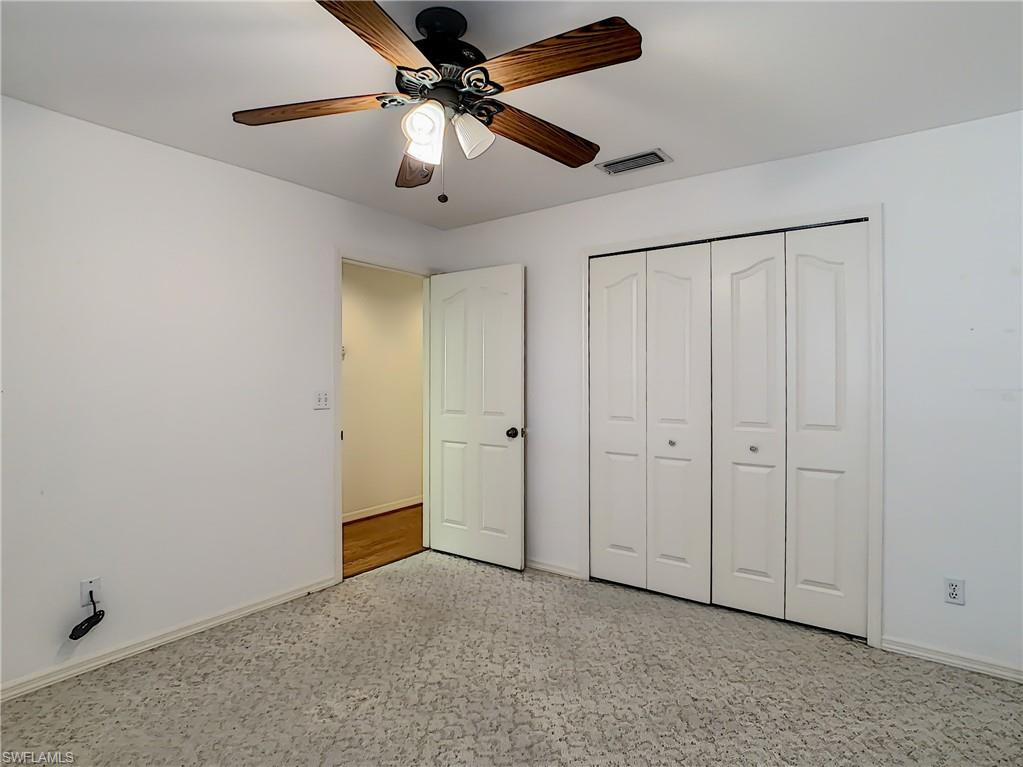 200 Napa Ridge Road East, Unit 6 Naples, FL 34119 - Photo 14 of 28 wooden floor in an empty room