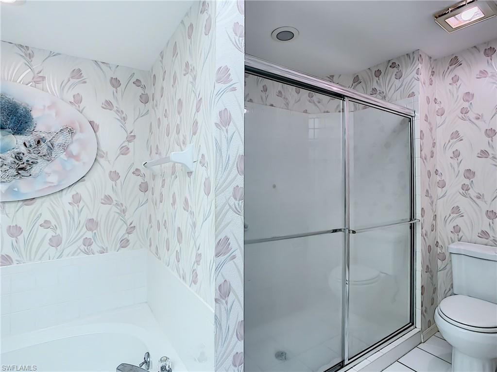 200 Napa Ridge Road East, Unit 6 Naples, FL 34119 - Photo 20 of 28 a bathroom with a shower and toilet