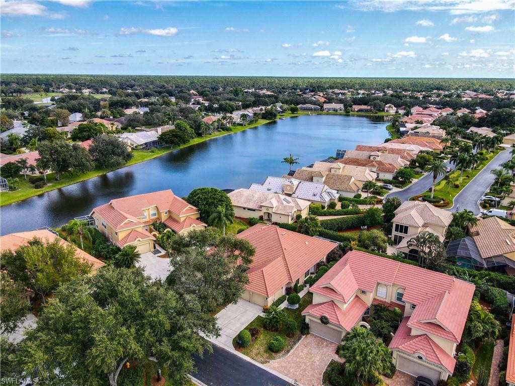 200 Napa Ridge Road East, Unit 6 Naples, FL 34119 - Photo 4 of 28 an aerial view of a houses with a lake view