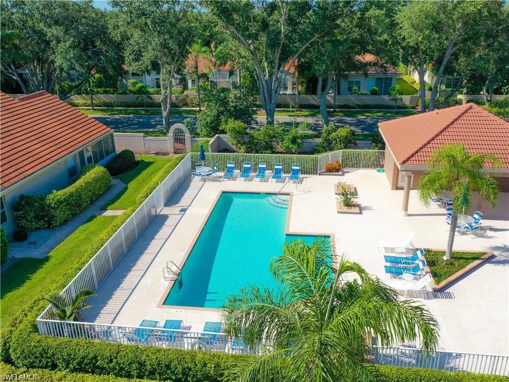 200 Napa Ridge Road East, Unit 6 Naples, FL 34119 - Photo 5 of 28 a view of yard with swimming pool and outdoor seating