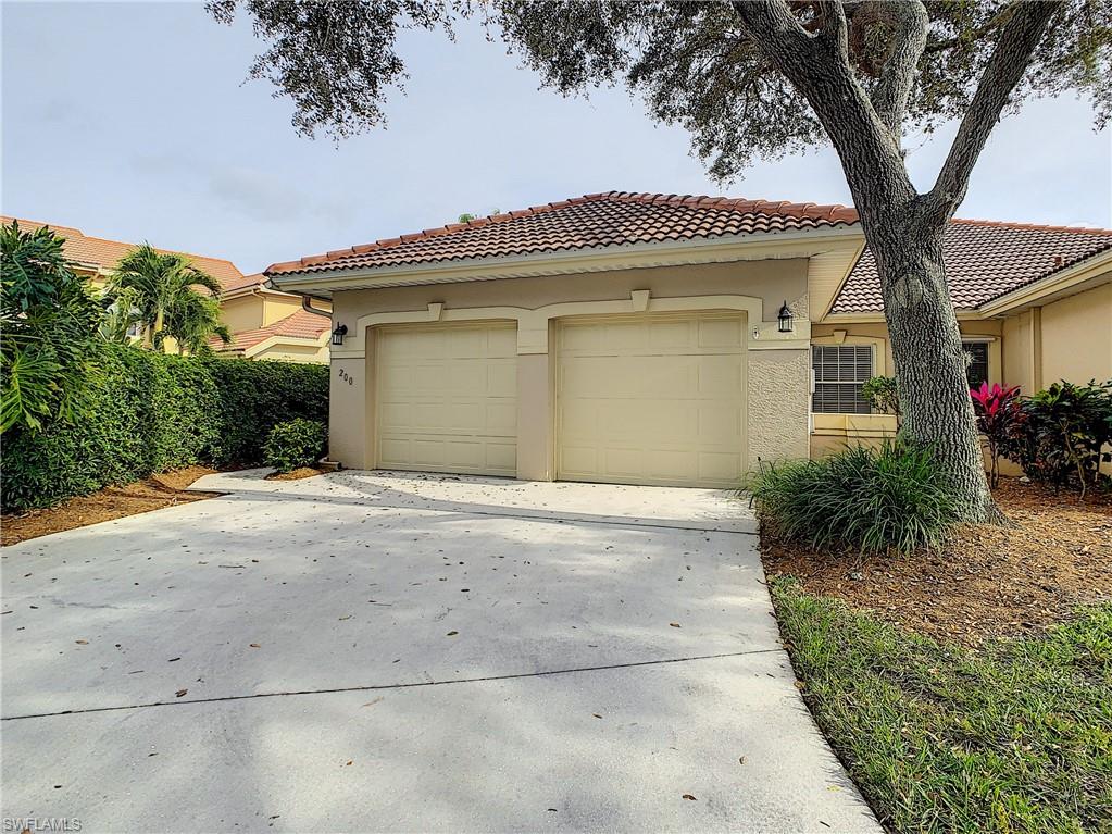 200 Napa Ridge Road East, Unit 6 Naples, FL 34119 - Photo 7 of 28 a front view of a house with a yard and a garage