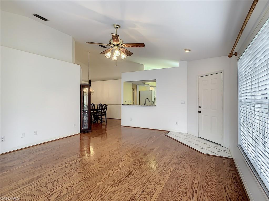 200 Napa Ridge Road East, Unit 6 Naples, FL 34119 - Photo 8 of 28 wooden floor in an empty room with a window