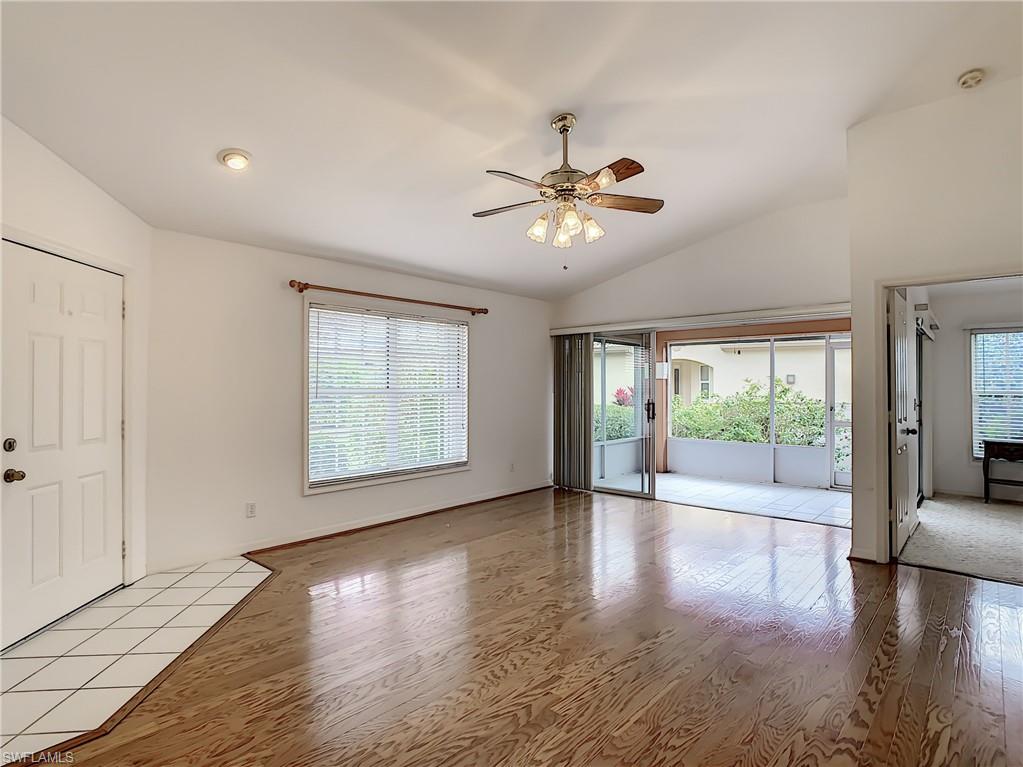 200 Napa Ridge Road East, Unit 6 Naples, FL 34119 - Photo 9 of 28 a view of an empty room with wooden floor and a window