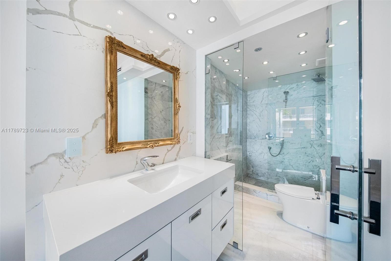 3 Island Avenue, Unit 3C Miami Beach, FL 33139 - Photo 17 of 73 a bathroom with a sink a toilet and shower