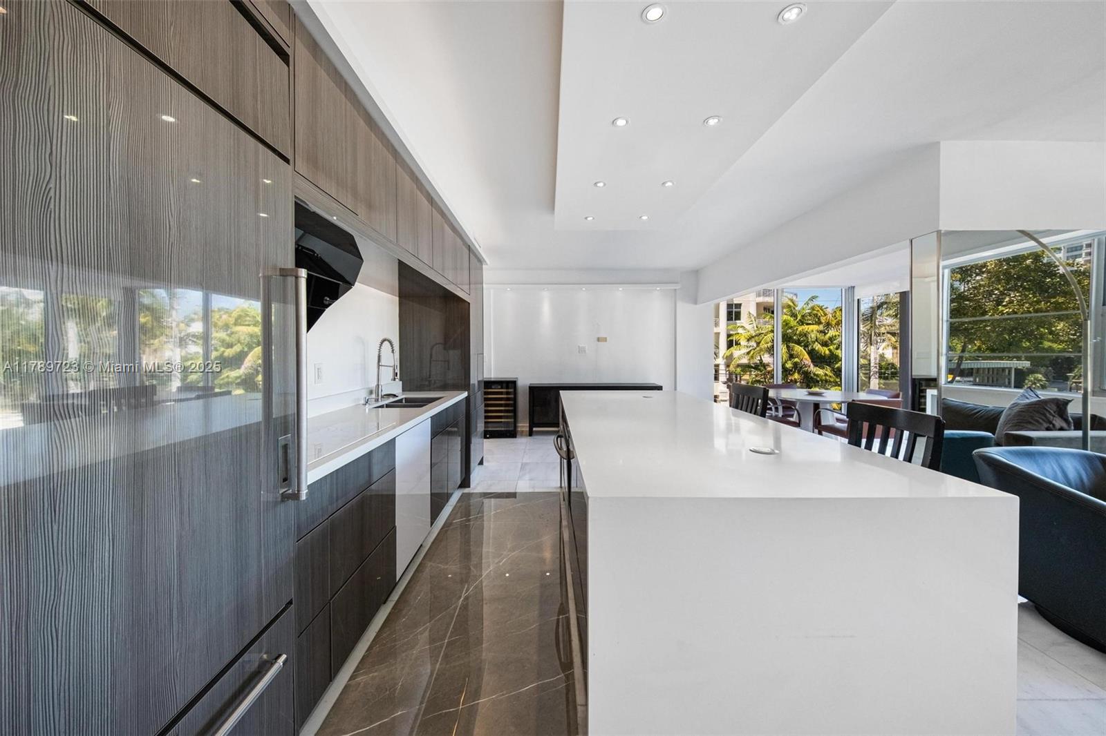 3 Island Avenue, Unit 3C Miami Beach, FL 33139 - Photo 31 of 73 a large kitchen with stainless steel appliances a large counter top a stove and a sink