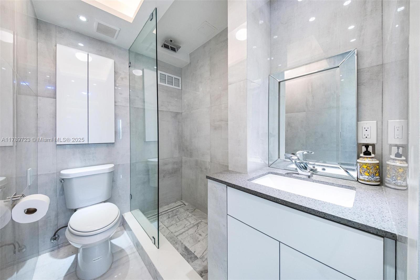 3 Island Avenue, Unit 3C Miami Beach, FL 33139 - Photo 10 of 73 a bathroom with a sink a toilet and shower