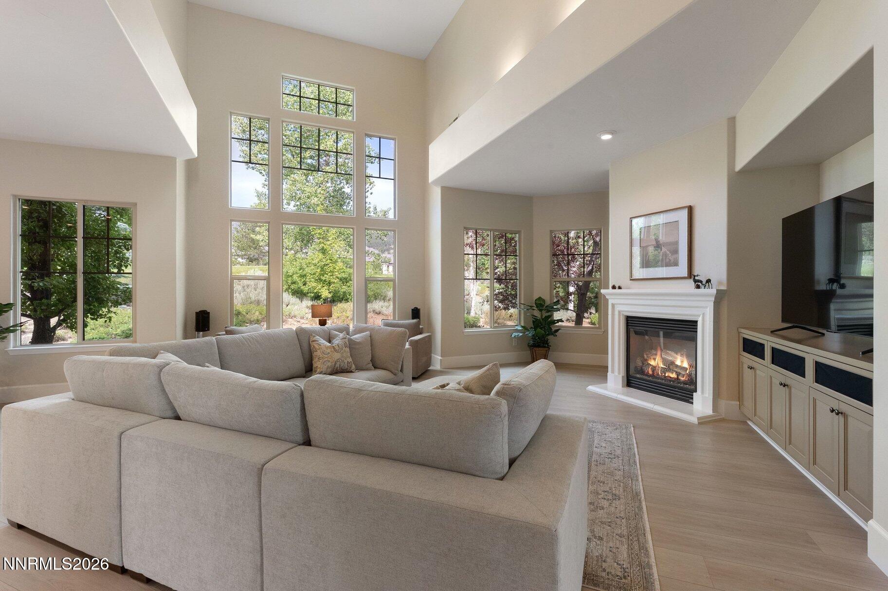 16925 Rue Du Parc Reno, NV 89511 - Photo 9 of 34 a living room with furniture a chandelier and a fireplace