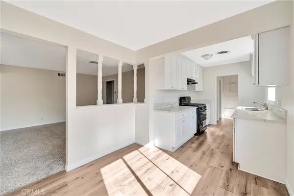 a kitchen with a sink stove and cabinets