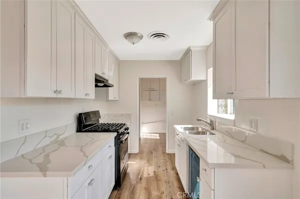 a kitchen that has a sink and a stove