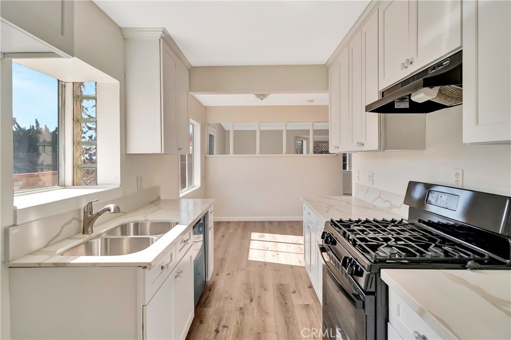 38453 3rd Street East Palmdale, CA 93550 - Photo 15 of 38 a kitchen that has a sink and a stove