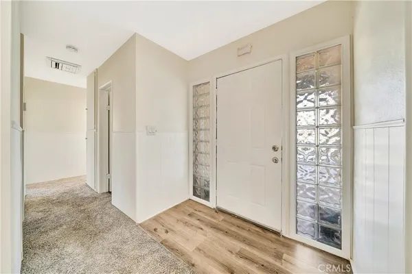 a view of a hallway with closet and bathroom
