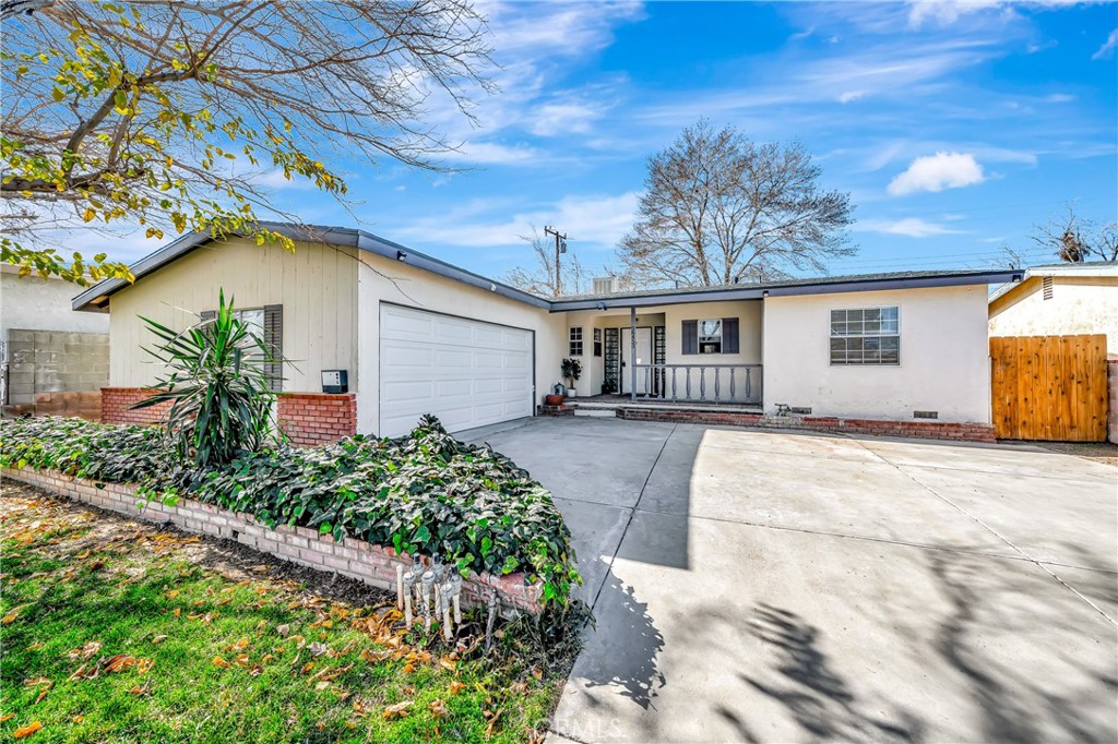 38453 3rd Street East Palmdale, CA 93550 - Photo 2 of 38 a front view of a house with a yard and potted plants