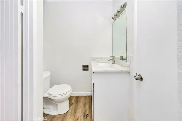 a view of storage and utility room with wooden floor