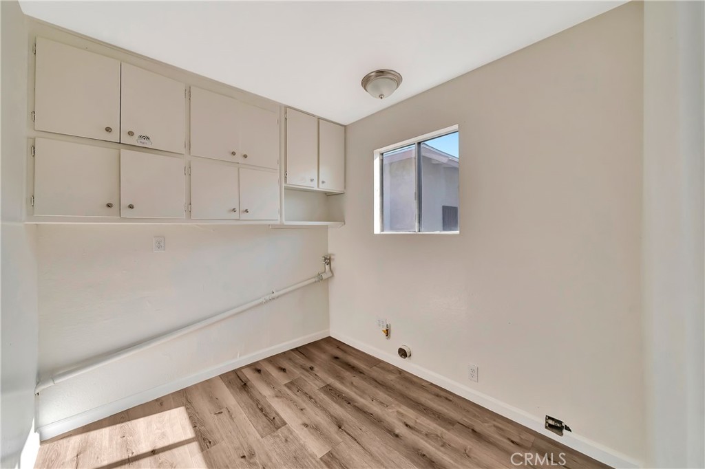 38453 3rd Street East Palmdale, CA 93550 - Photo 31 of 38 a view of storage and utility room with wooden floor