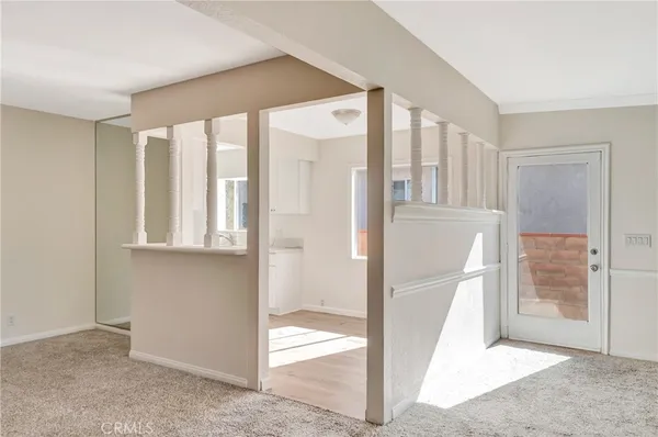 a room with kitchen island a sink and a stove top oven