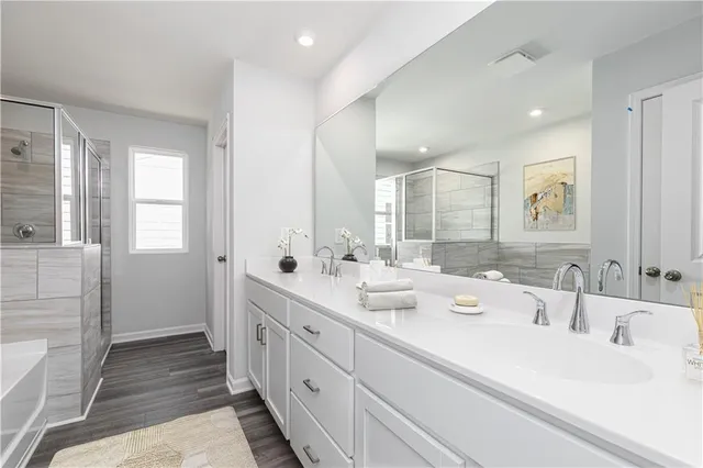 a bathroom with double vanity and a mirror