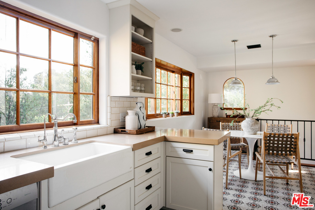 8515 Ridpath Drive Los Angeles, CA 90046 - Photo 12 of 20 a kitchen with a sink cabinets and dining table view