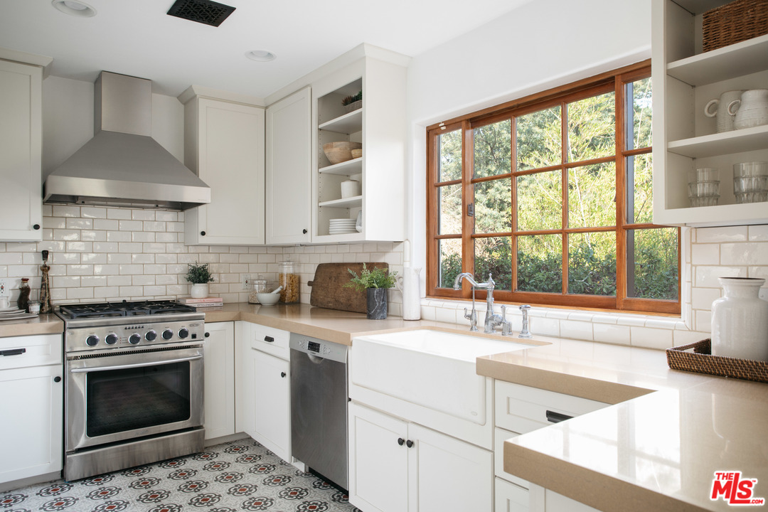 8515 Ridpath Drive Los Angeles, CA 90046 - Photo 13 of 20 a kitchen with a stove a sink and a window